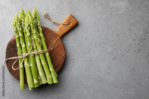 Bunch of green asparagus on concrete background photo