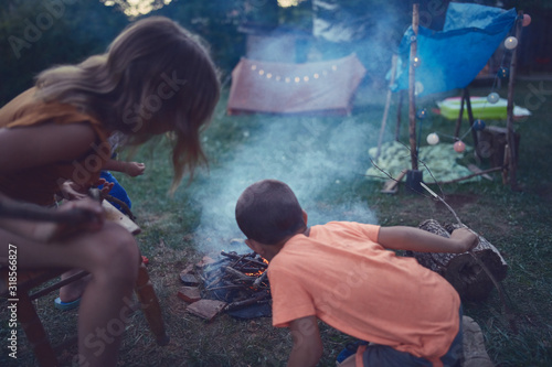 Kids making campfire at evening time. © astrosystem