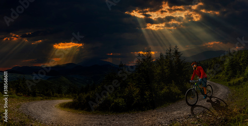 Cycling man riding on bike at sunset mountains forest landscape. Cycling MTB enduro flow trail track. Outdoor sport activity.