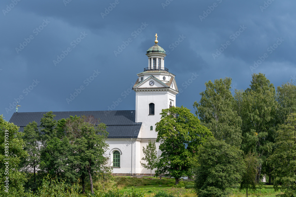 White church in a lush green environment