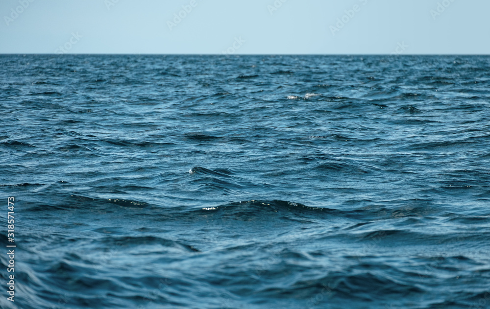 Waves on ocea with clear blue sky