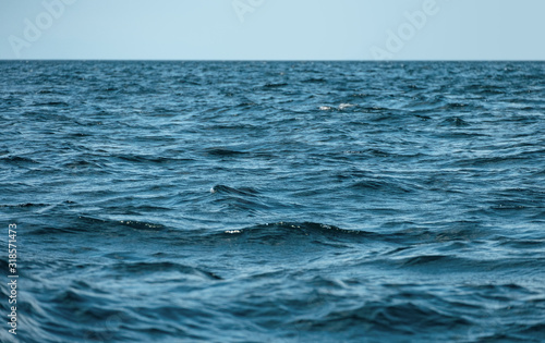 Waves on ocea with clear blue sky photo