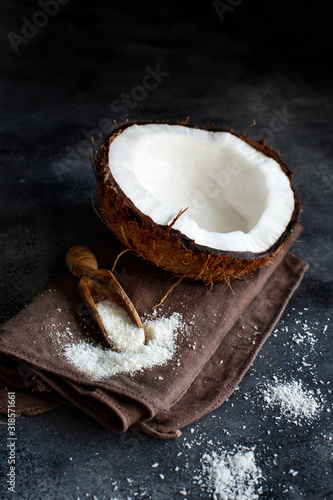 Coconut flour in a wooden spoon close up