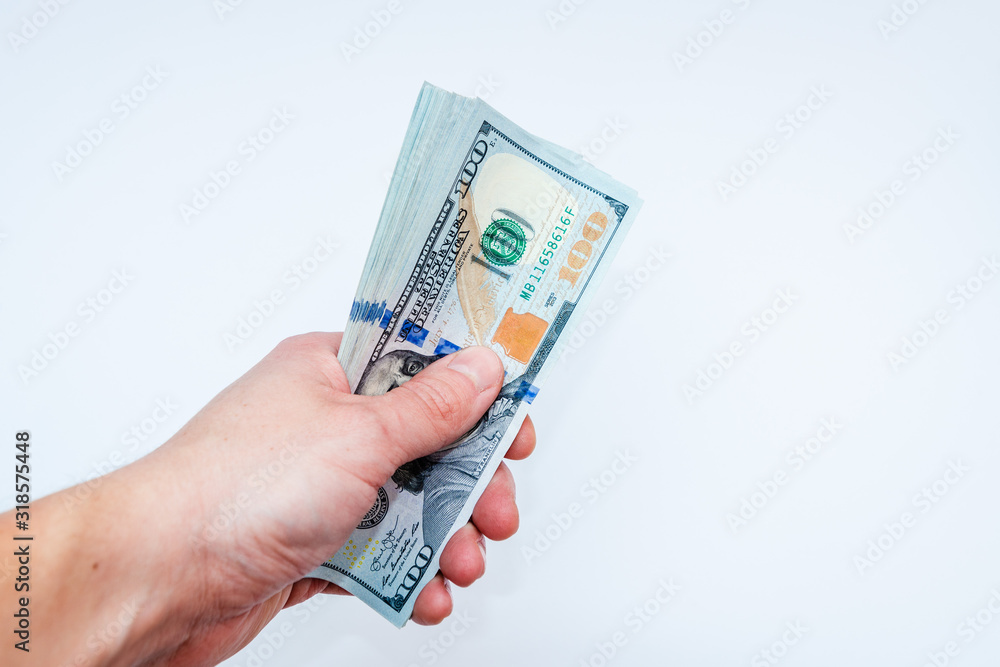 Hand holding dollars on white backgrounds. Isolated Hand holding dollars on white backgrounds. Isolated