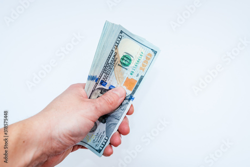 Hand holding dollars on white backgrounds. Isolated