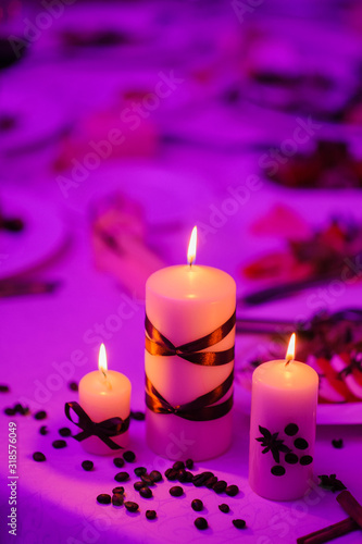 Beautiful  decorated table with flower decorations and red candles. Christmas evening or wedding party decoration.