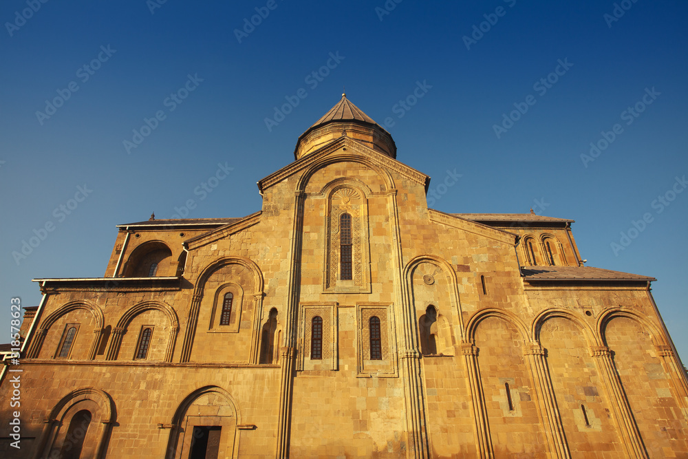 Georgian Culture and Travel concept. Svetitskhoveli Cathedral in Mtskheta, Georgia. Sunny day with blue sky. Text space. Outdoor shot