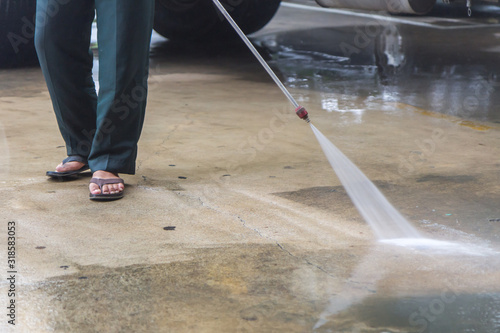 Man cleaning the ground floor, Outdoor floor cleaning with high pressure water jet
