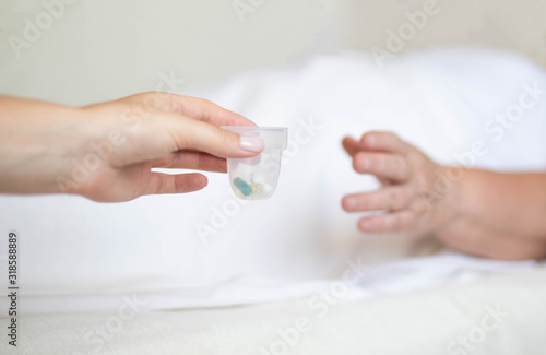 Doctor holds out anti-hypertension pills and antidepressants to an elderly woman, Pill classification concept, hepatoprotectors