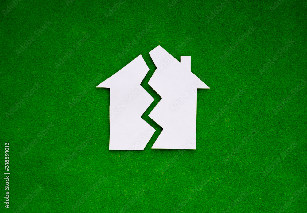 two halves of the house on a green background. the concept of property, the real estate market.