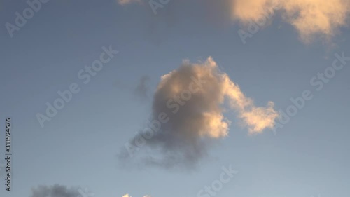 Beautiful evening blue sky at sunset with flaming bright light clouds