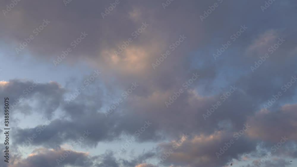 Beautiful evening blue sky at sunset with flaming bright light clouds Beautiful evening blue sky at sunset with flaming bright light clouds