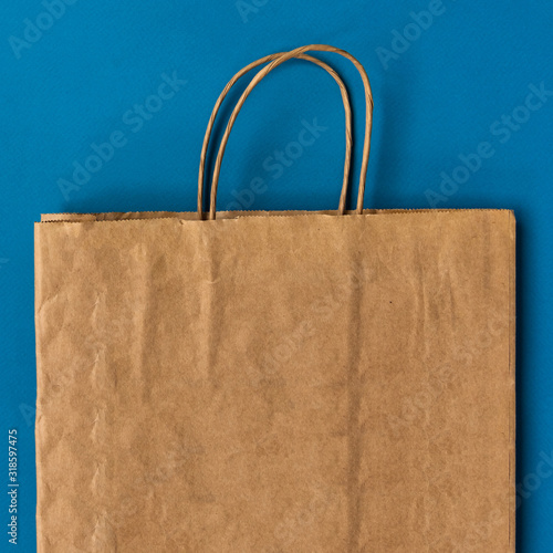 One Empty Brown Paper Bag. Recycled paper Shopping Bag on color field.