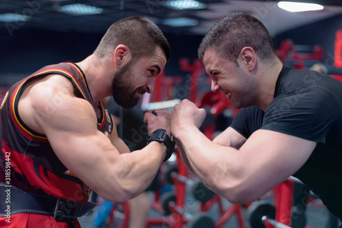 Two boxers looking at each other very close and trying to intimidate the other before the fight. Looking to each other with serious face and ready to attack. photo