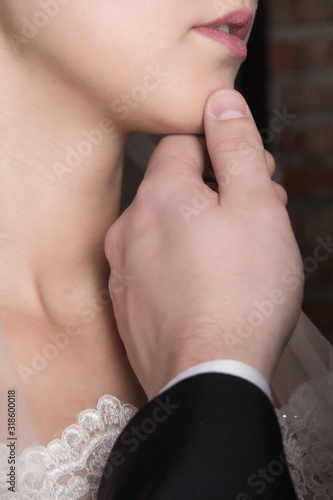 sexy picture of a gentleman holding his woman by her chin. hot sensual couple in studio.Close up © Кристина Панова