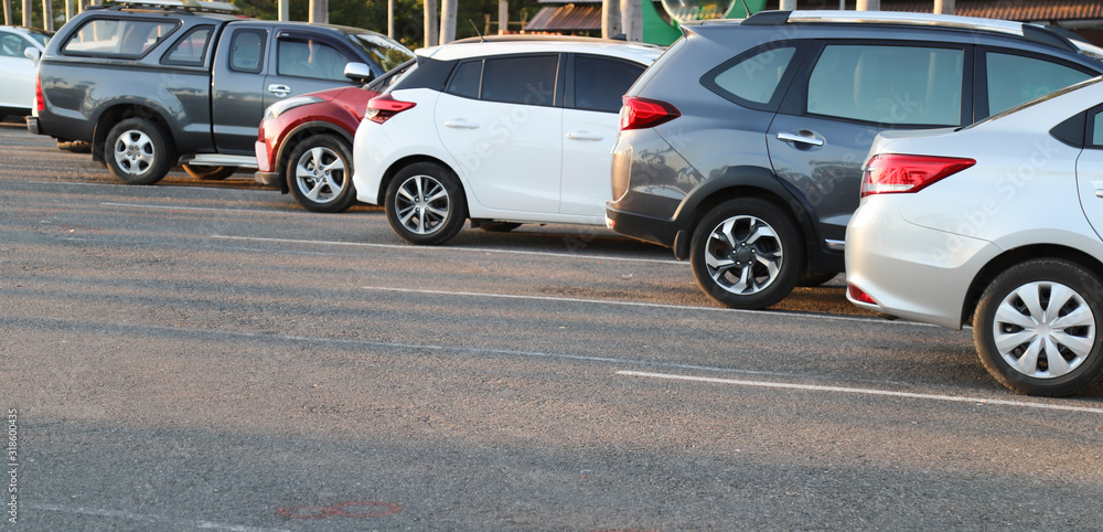 Closeup of rear, back side of blue car with other cars parking in outdoor parking area in sunny evening. Closeup of rear, back side of blue car with other cars parking in outdoor parking area in sunny evening.