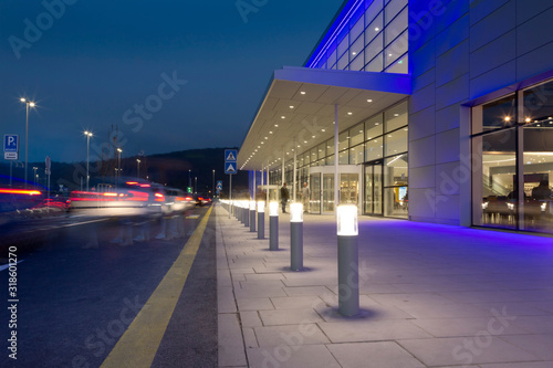 a row of column lighting in front the modern building at night
