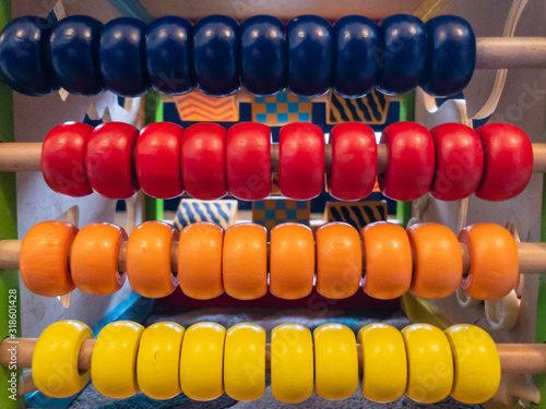 Colourful wooden beads on a child   s abacus toy.