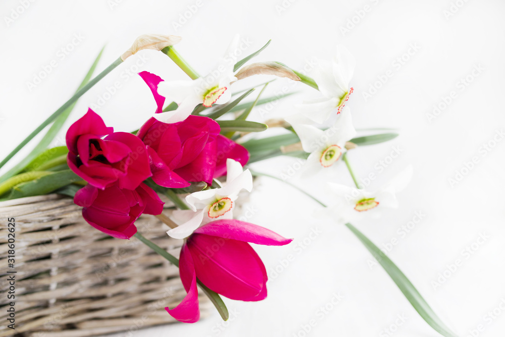 Bouquet of spring flowers in a basket on a light background, soft focus Bouquet of spring flowers in a basket on a light background, soft focus