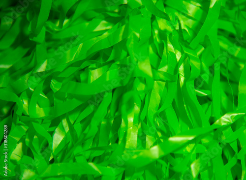 Abstract green background of thin rustling ribbons.