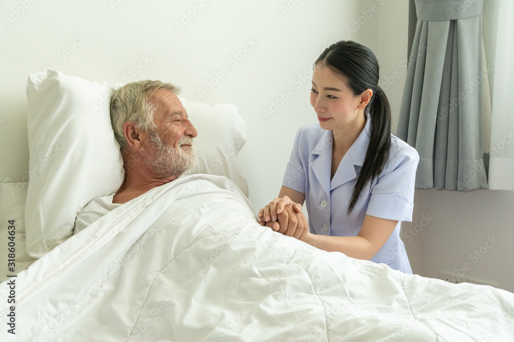 Young nurse take care senior man on a bed, A nurse checking sernior man, Senior man happniess and smiling with nurse, Health care concept Young nurse take care senior man on a bed, A nurse checking sernior man, Senior man happniess and smiling with nurse, Health care concept