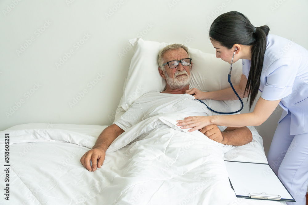 Young nurse take care senior man on a bed, A nurse checking sernior man, Senior man happniess and smiling with nurse, Health care concept Young nurse take care senior man on a bed, A nurse checking sernior man, Senior man happniess and smiling with nurse, Health care concept