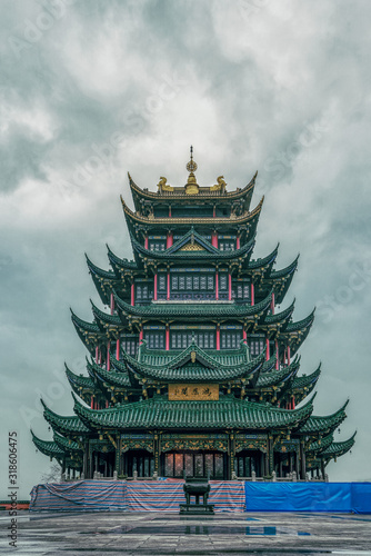 Fototapeta Ancient Hong'En Temple pagoda tower with green tile under overcast weather in Ch