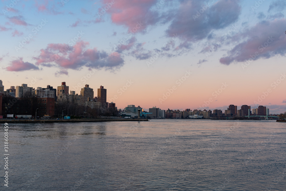 The East River between Astoria Queens and Roosevelt Island in New York City during a Sunset