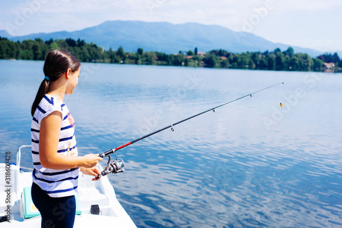 little girl on the pier with fishing rod summer afternoon