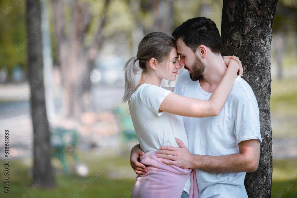 Young couple lover dating and hugging in love at spring garden park, copy space, Romantic love concept. Young couple lover dating and hugging in love at spring garden park, copy space, Romantic love concept.