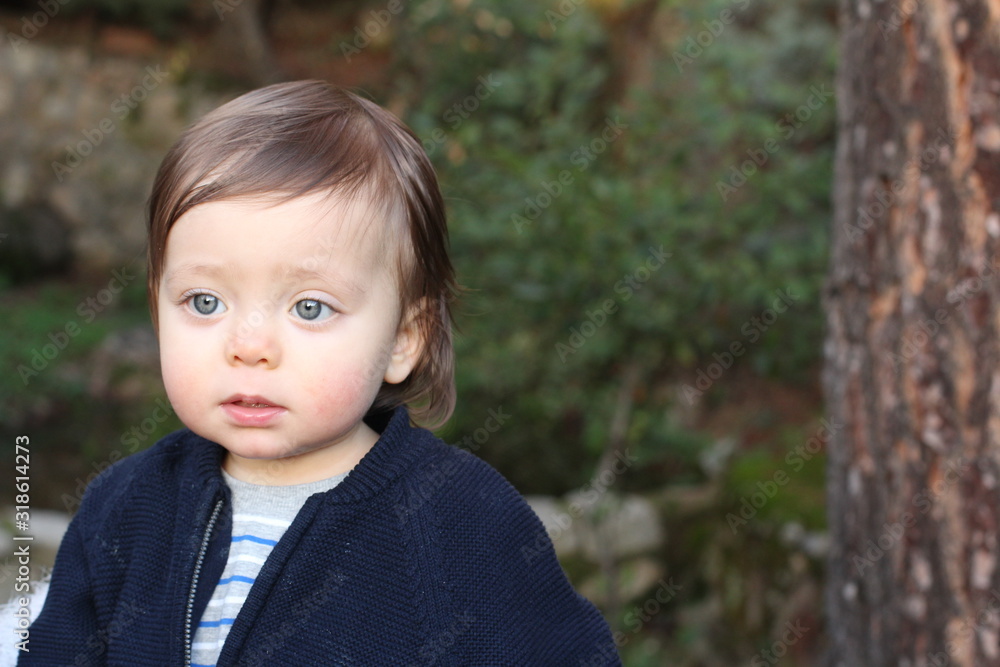 Sad one year old baby looking away Sad one year old baby looking away