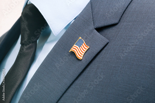 Man in suit with tie and USA flag pin on chest photo