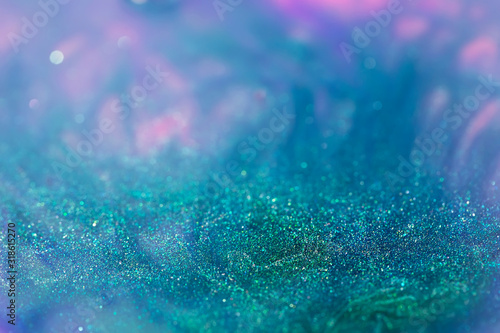 macro shot of turquoise alcohol ink with glitter dissolved in water, sparkle abstract background