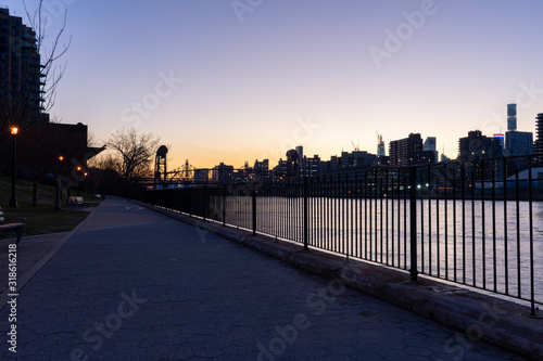 Empty Waterfront at Rainey Park in Astoria Queens New York along the East River with a view of Roosevelt Island and the Manhattan Skyline during Sunset