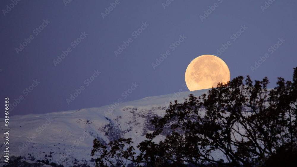 Supermoon full moon over the Jura mountains between Switzerland and France Supermoon full moon over the Jura mountains between Switzerland and France