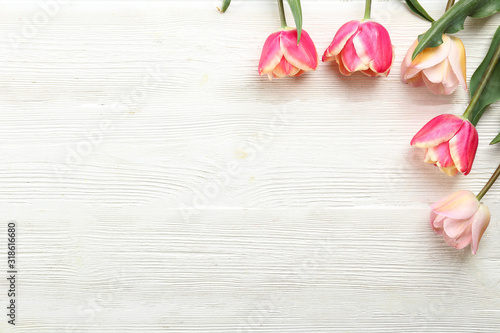 Bunch of spring flowers on textured table backgound with a lot of copy space for text. Top view, close up, flat lay composition.