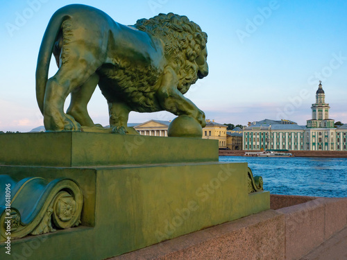 Saint Petersburg. Russia. Lion on the waterfront. Admiralty embankment in St. Petersburg. Kunstkammer. Architecture Of St. Petersburg. Kuntskamera against the blue sky. Two banks of the Neva river.