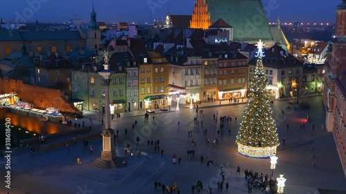 Old Town square in city of Warsaw in Poland at night during Christmas season, elevated zoom out shot