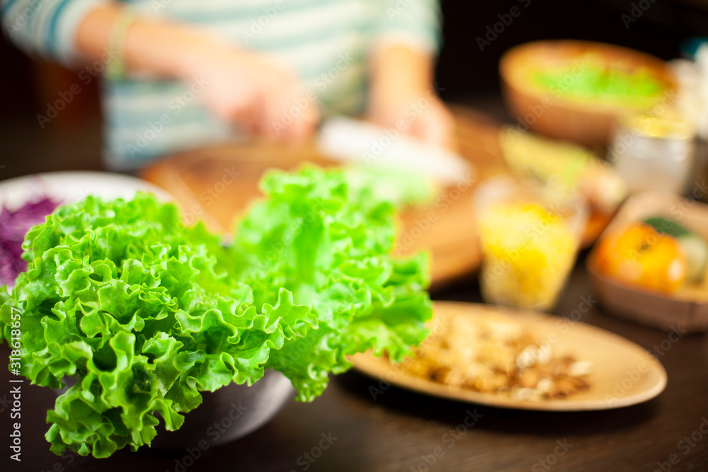 Woman prepares a vegetarian recipe with salad, corn, dried fruit and cheese Woman prepares a vegetarian recipe with salad, corn, dried fruit and cheese