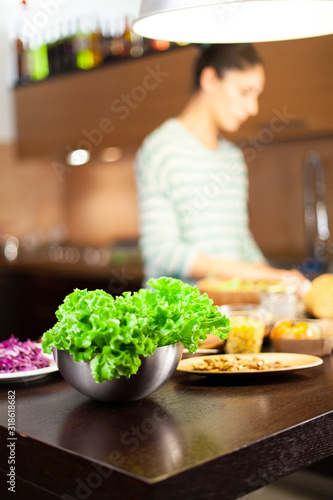 Woman prepares a healthy vegetarian recipe in a modern kitchen