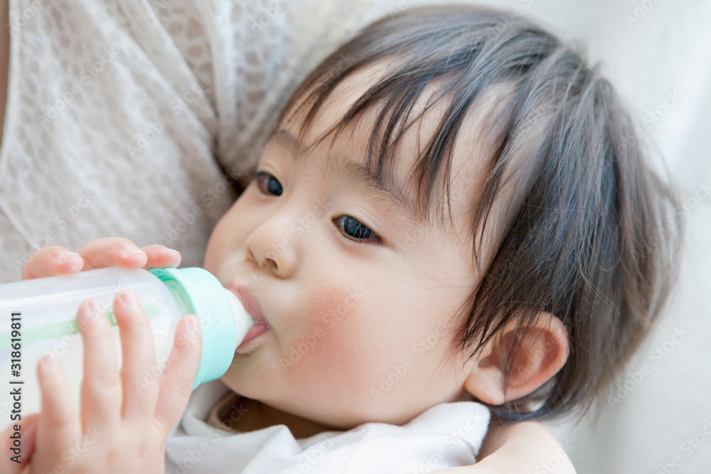 Toddler boy drinking milk from bottle Toddler boy drinking milk from bottle