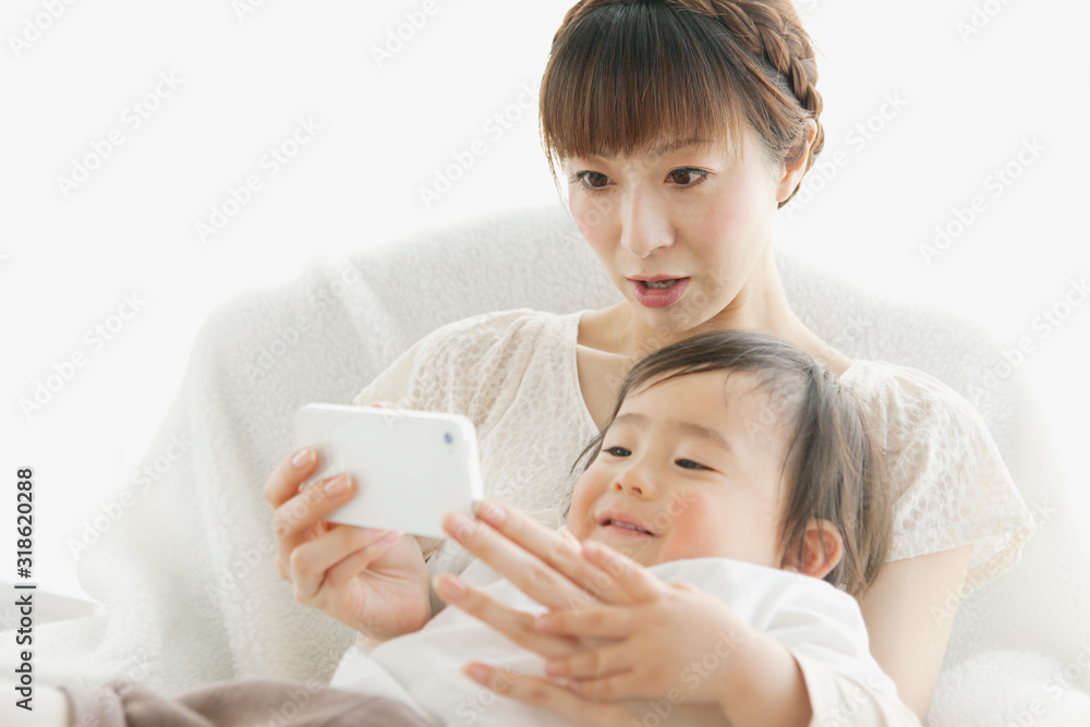 Mother and toddler son looking at mobile phone Mother and toddler son looking at mobile phone