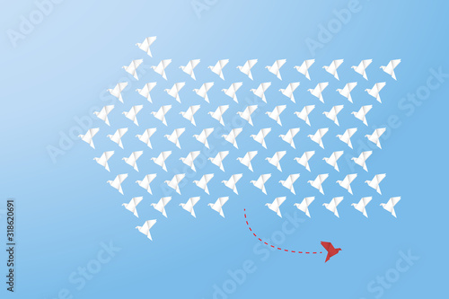 Think differently - One red unique different paper bird flying opposite way of identical white ones. 