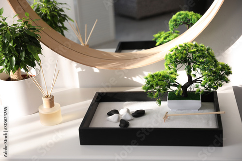 Photography Beautiful miniature zen garden on white table indoors