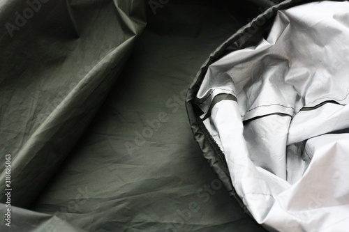 Quadro su tela Green raincoat for walking close up view