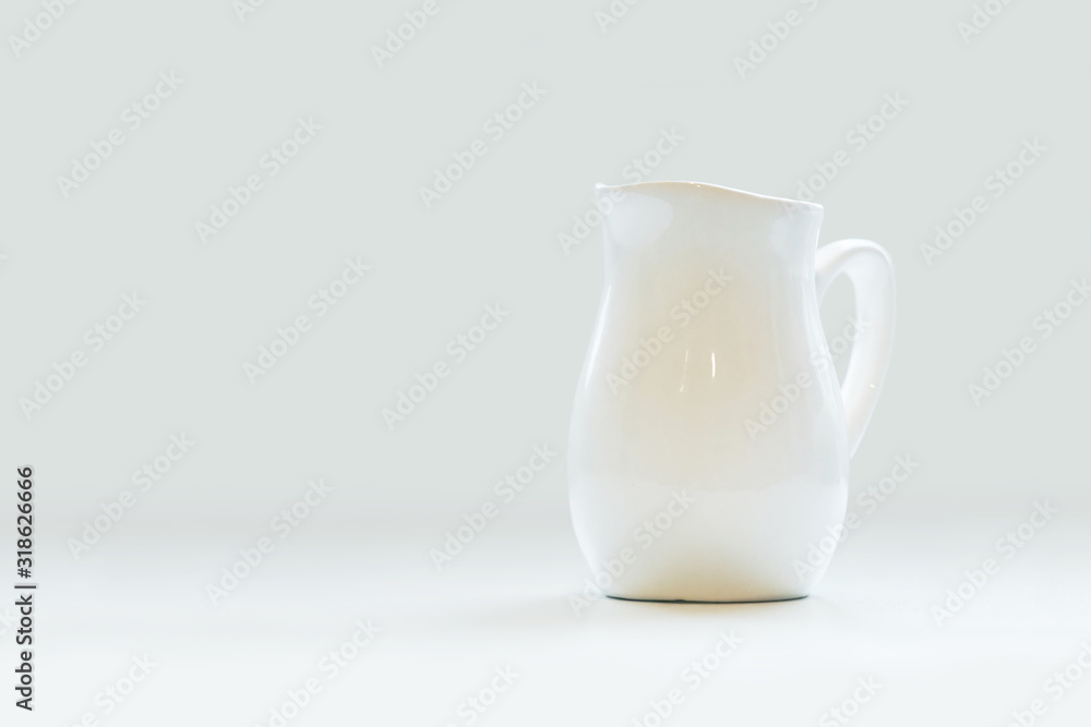 White porcelain milk jug on white background. Pitcher White porcelain milk jug on white background. Pitcher