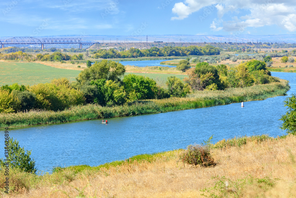 Obraz premium View of the Southern Bug River and the railway bridge on the horizon.