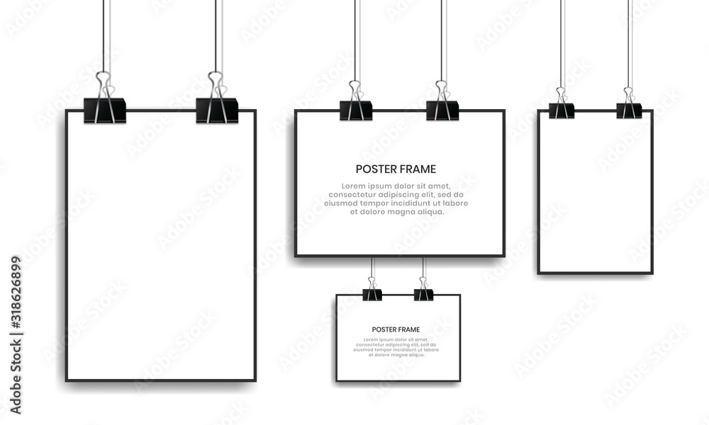 Blank white poster hanging with binder clips.