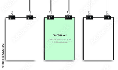 Blank posters hanging with binder clips.