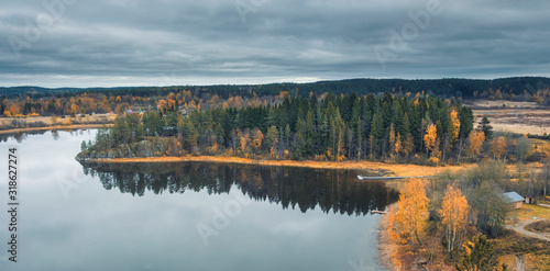 Fototapeta Naklejka Na Ścianę i Meble -  View from the top of the Snake Mountain on Lake Ladoga and a stone island with a forest, Skhera, near the town of Lahdenpohja in Karelia, Russia, in the autumn day